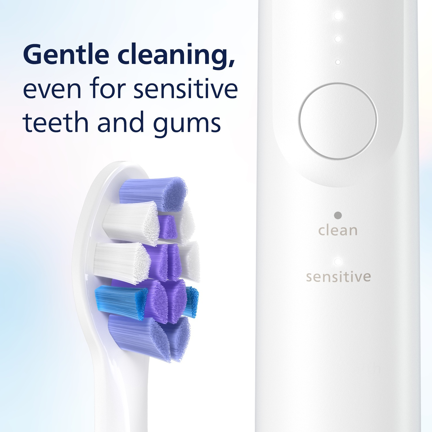 Tête de brosse à dents électrique blanche avec des poils bleus, violets et blancs, à côté du manche blanc avec des indicateurs de nettoyage et de sensibilité.