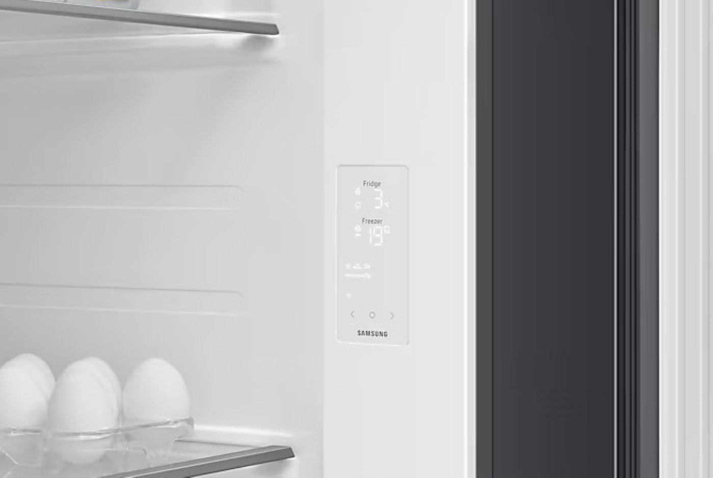 Wnętrze lodówki z panelem wyświetlania temperatury pokazującym temperaturę chłodziarki i zamrażarki.