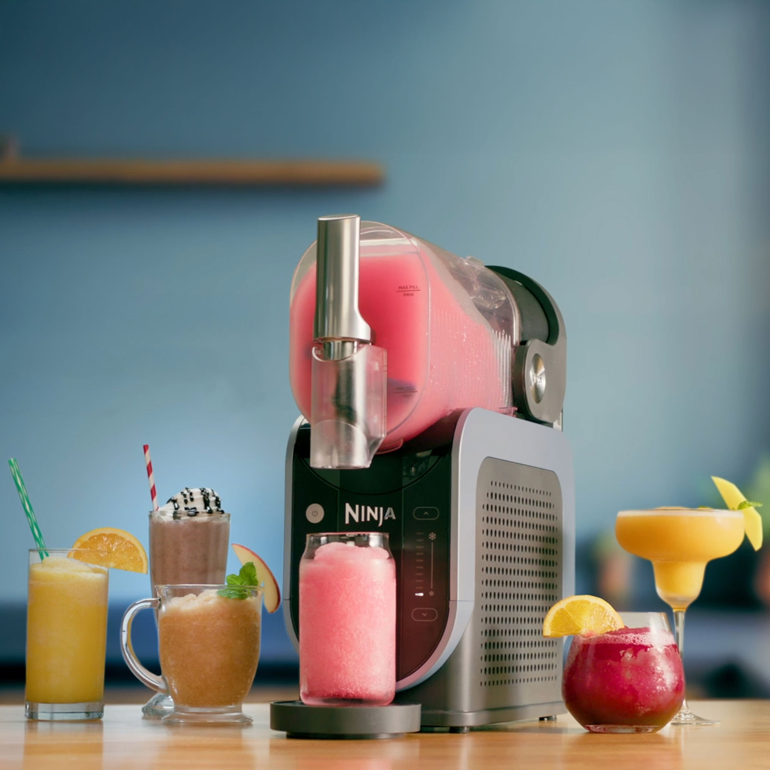 Ninja machine with multiple slush drinks on a table.