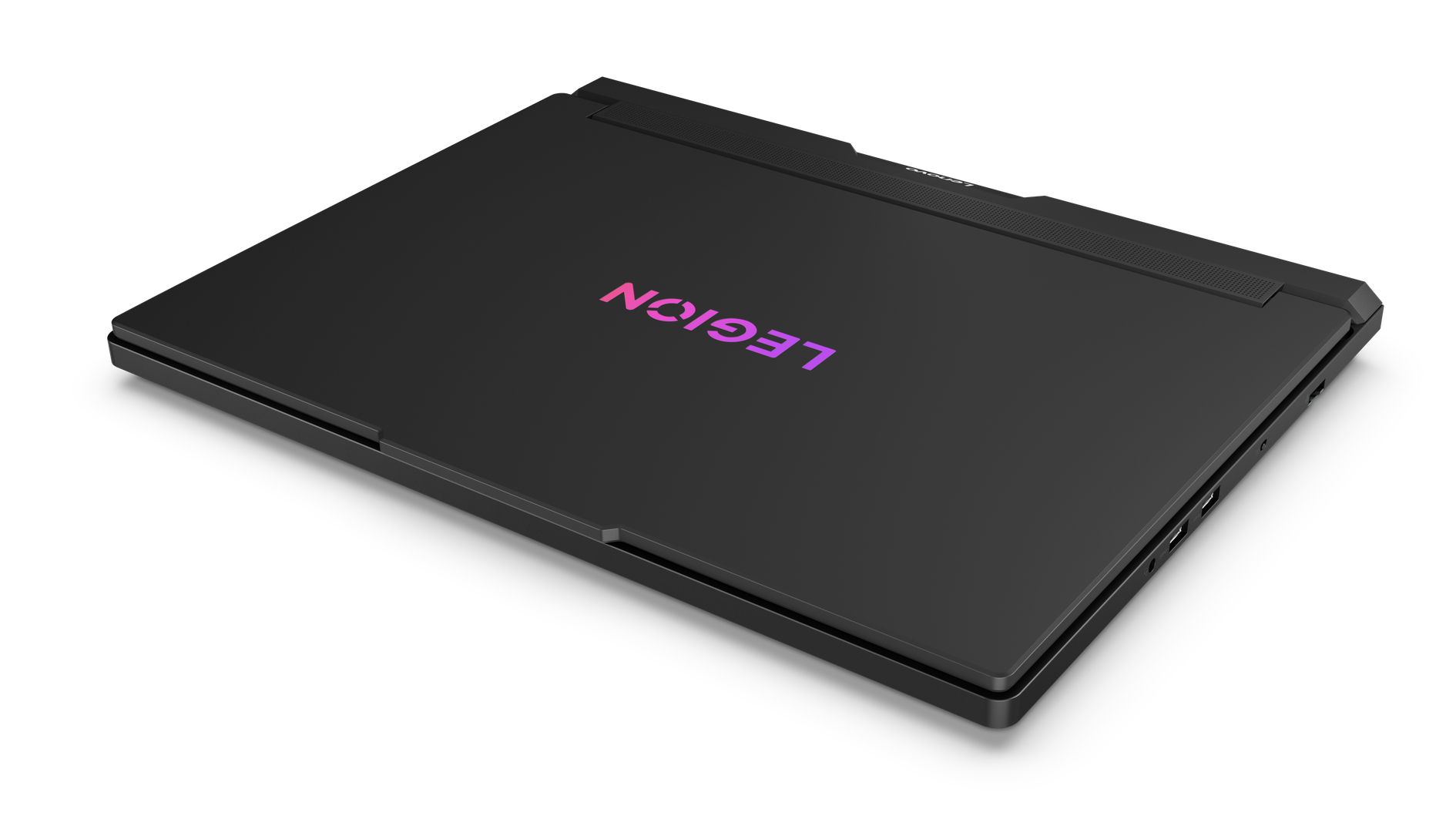 Czarny laptop Legion zamknięty. Logo Legion w kolorze różowym i fioletowym. Czarne tło. Logo Lenovo.