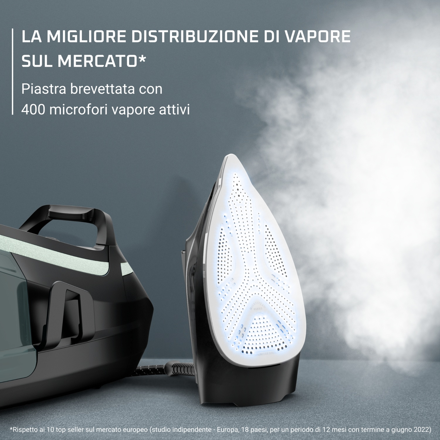 Primo piano della piastra del ferro con fori vapore. Mostra un ferro e parte della base.