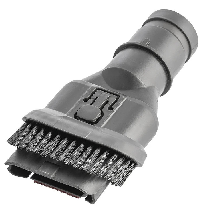Zbliżenie szarej przystawki szczotkowej do odkurzacza.