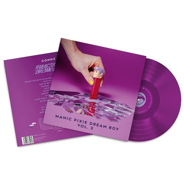 Albumcover mit lila Hintergrund. Eine Hand hält einen Pez-Spender über einem zerbrochenen Spiegel. Vinyl und Cover sichtbar.