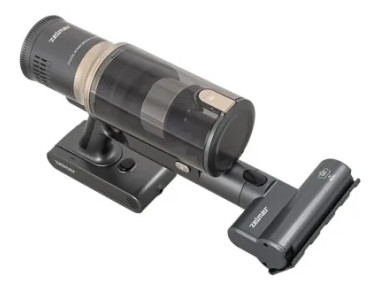 Bezprzewodowy odkurzacz, szary i czarny, z przezroczystym pojemnikiem na kurz i akcesoriami.