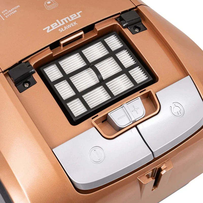 Widok komory filtra złotego odkurzacza. Zawiera filtr i elementy sterujące.