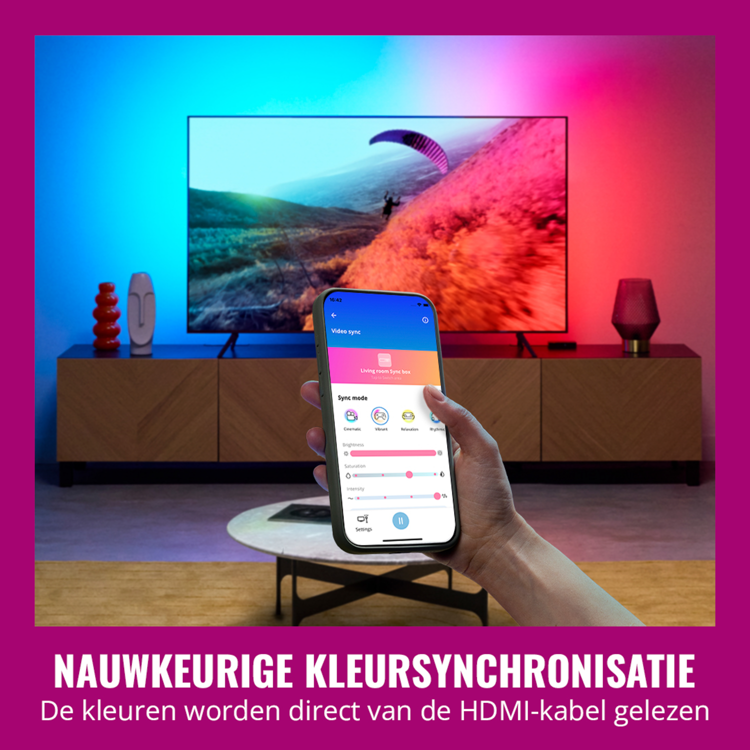 Person holding a phone showing a TV sync app. The TV displays a colorful scene.