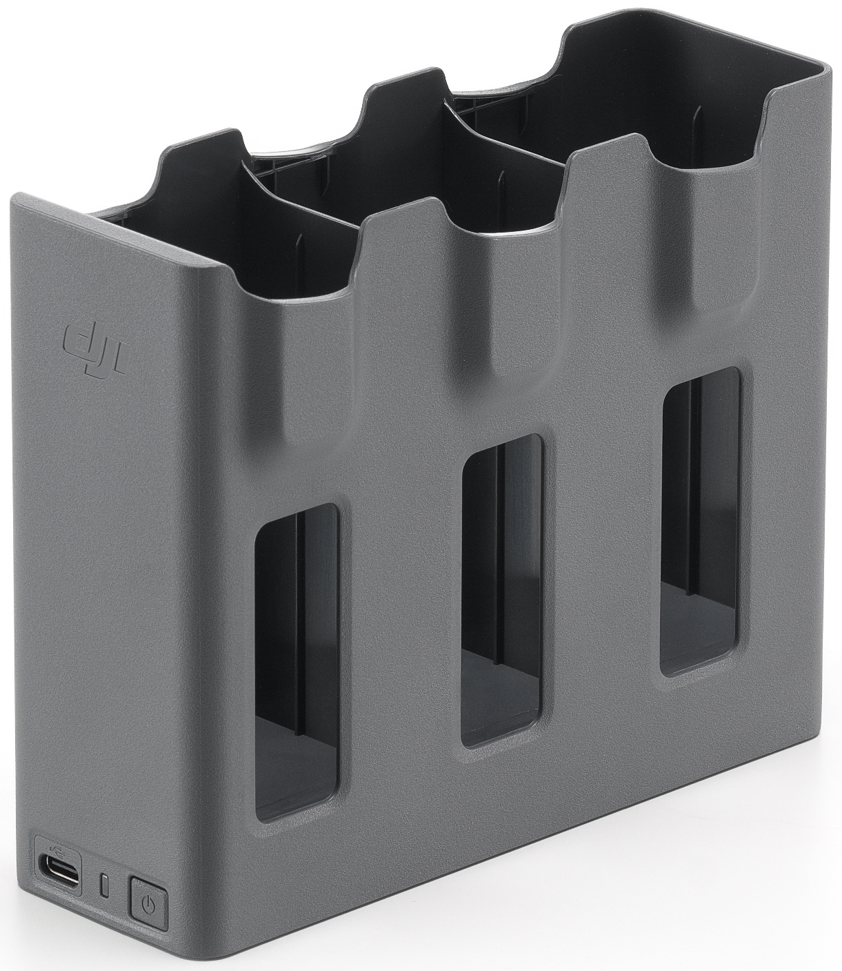 Hub de charge gris avec trois emplacements, fond noir, trois trous rectangulaires visibles.