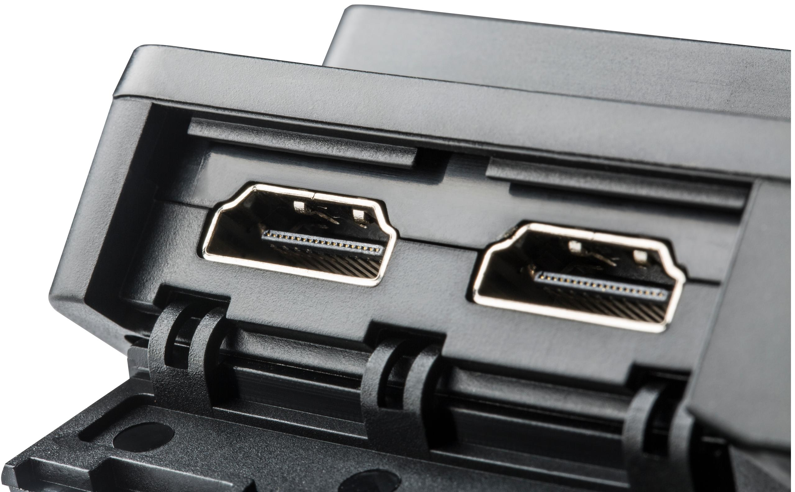 Gros plan des ports HDMI sur un moniteur noir. Les ports sont de couleur argentée.