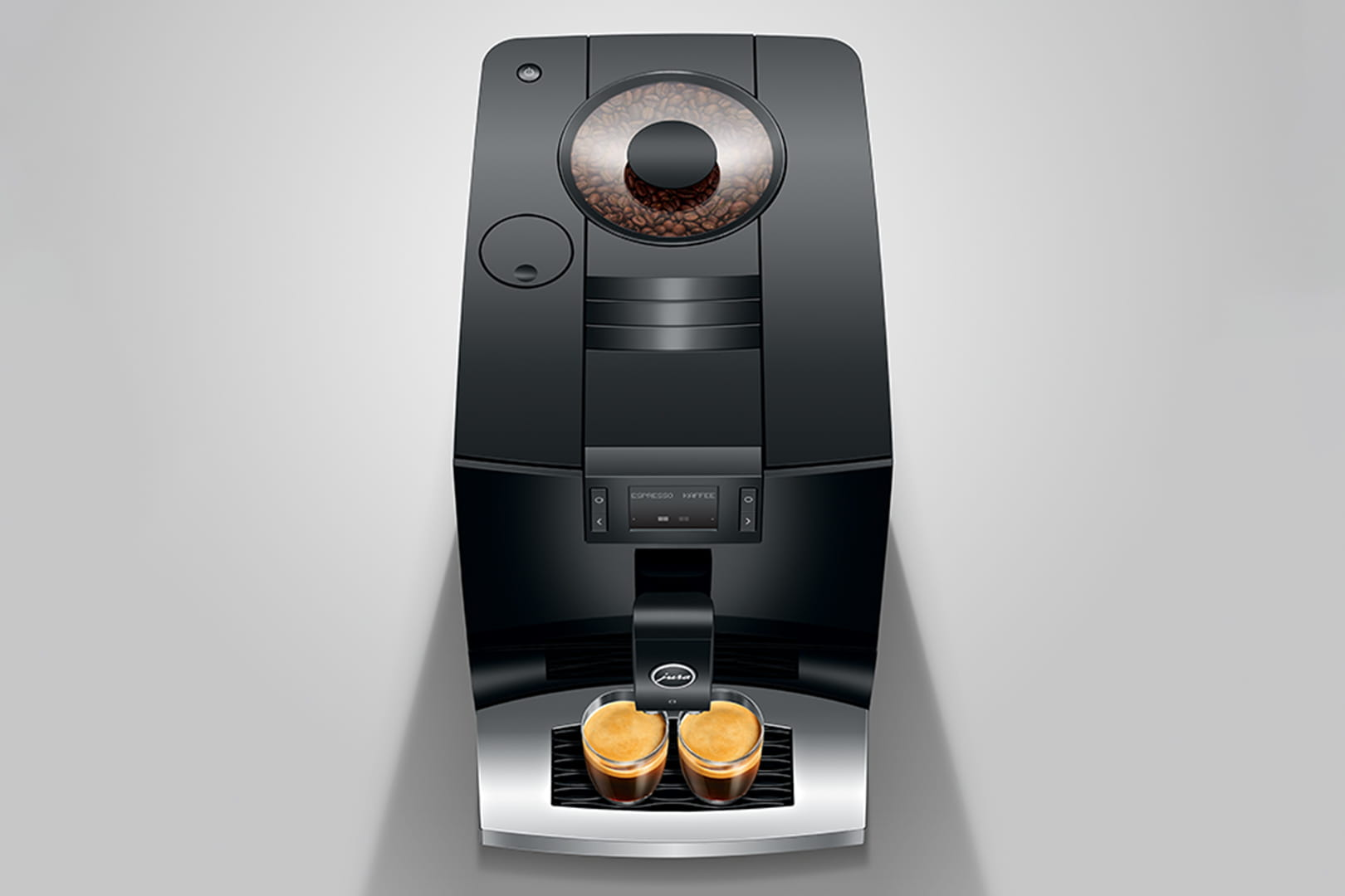 Vista dall'alto di una macchina per espresso Jura nera. Due bicchieri di caffè sul vassoio.