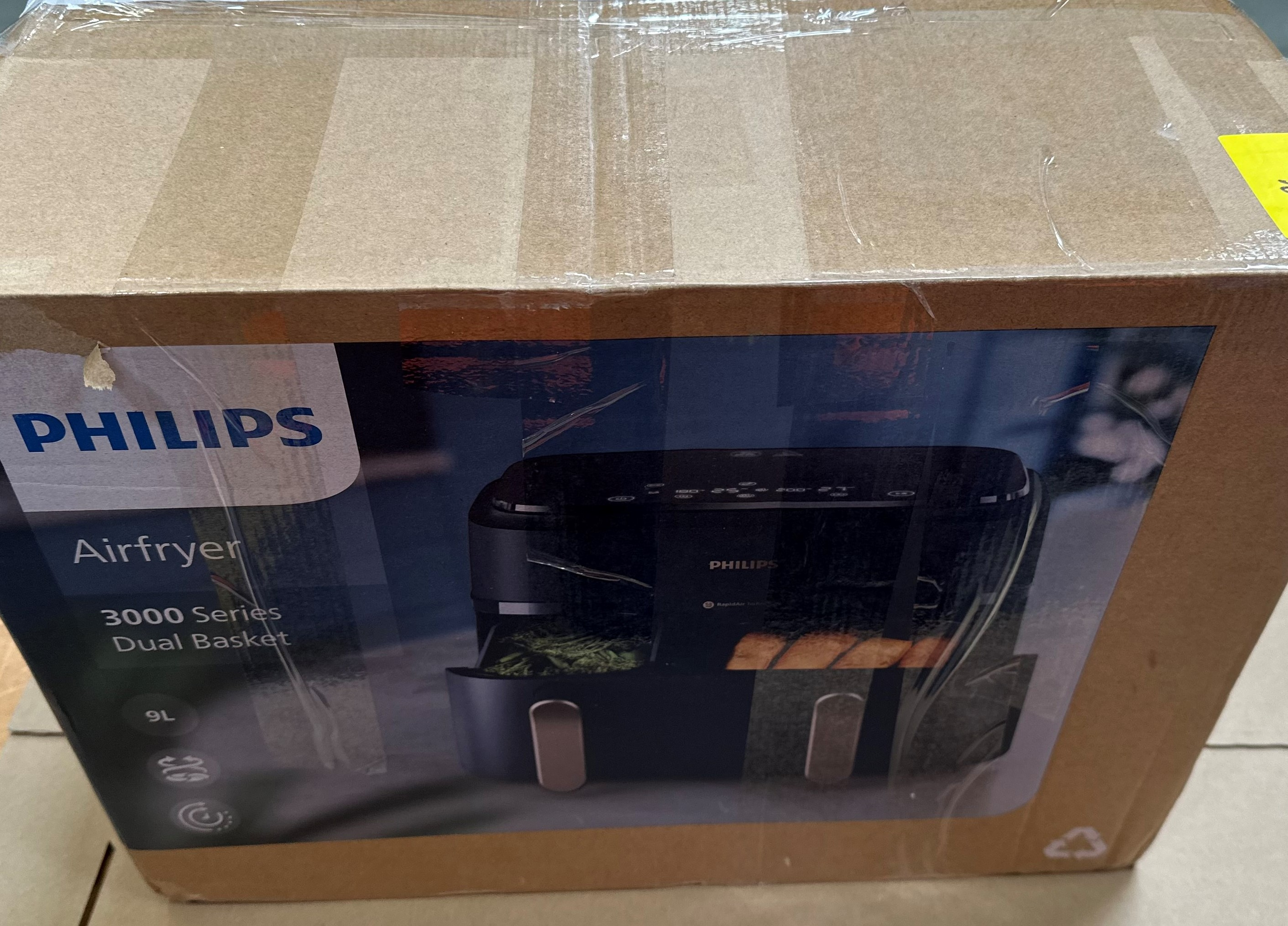 Pudełko Philips Airfryer. Jest brązowe ze zdjęciem urządzenia, czarne i ma nazwę marki.