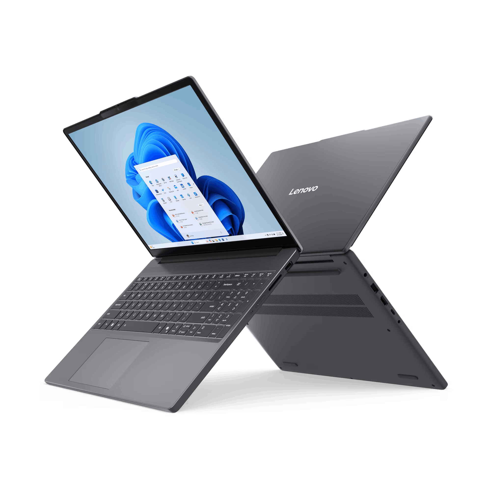 Dos portátiles Lenovo grises sobre fondo negro, uno abierto mostrando Windows 11, el otro cerrado con el logo Lenovo.