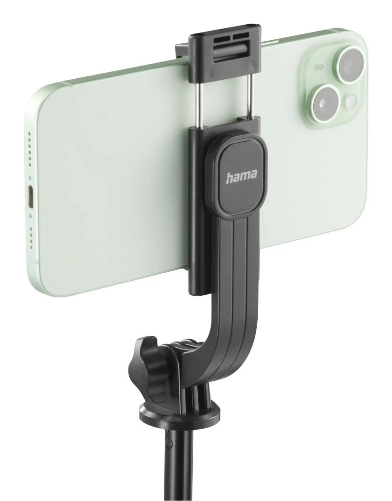 Telefon przymocowany do czarnego uchwytu na telefon na białym tle.