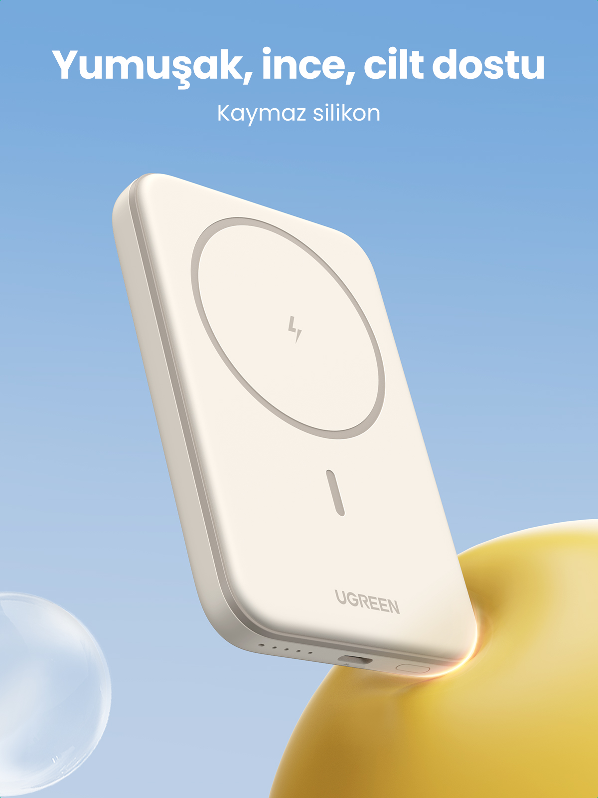 Ugreen kablosuz şarj cihazı, krem rengi, telefon silüeti ile. Metin: Yumuşak, ince, cilt dostu.