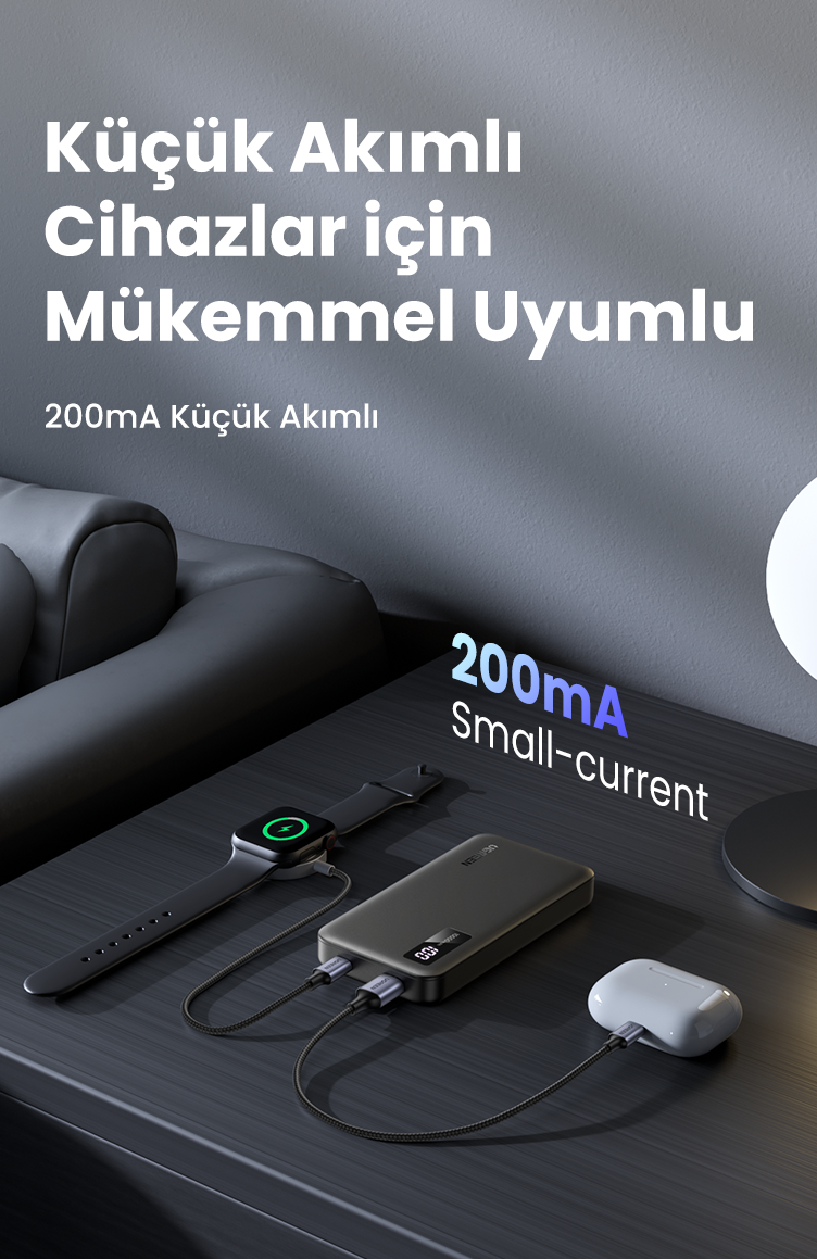Bir saat ve kulaklığı şarj eden powerbank. Arka planda bir lamba ile, karanlık bir yüzeyde.