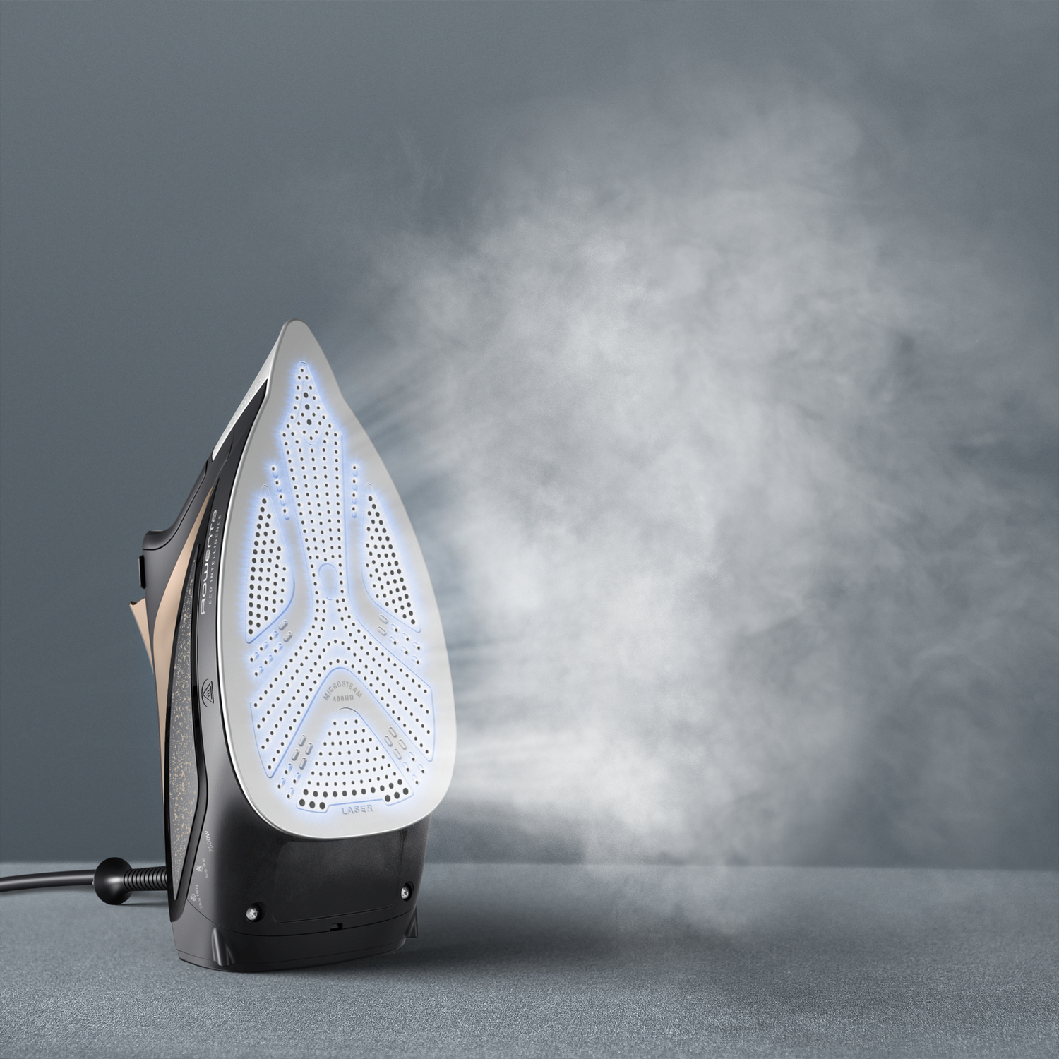 A black iron steaming, with a white base lit up, against a gray background with a steam cloud.