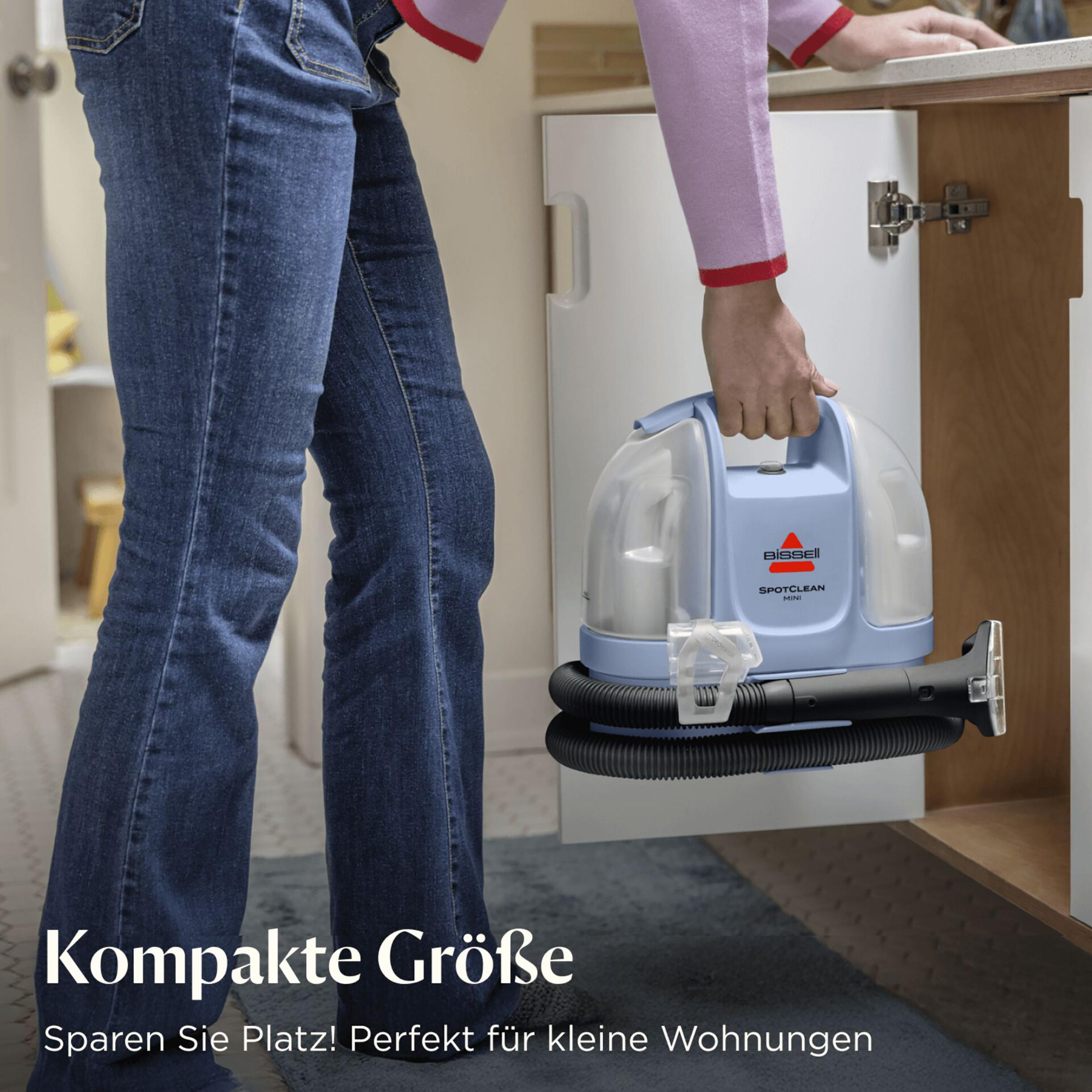 Eine Frau gießt Flüssigkeit in einen Reinigungstank, ein anderer Tank ist leer.