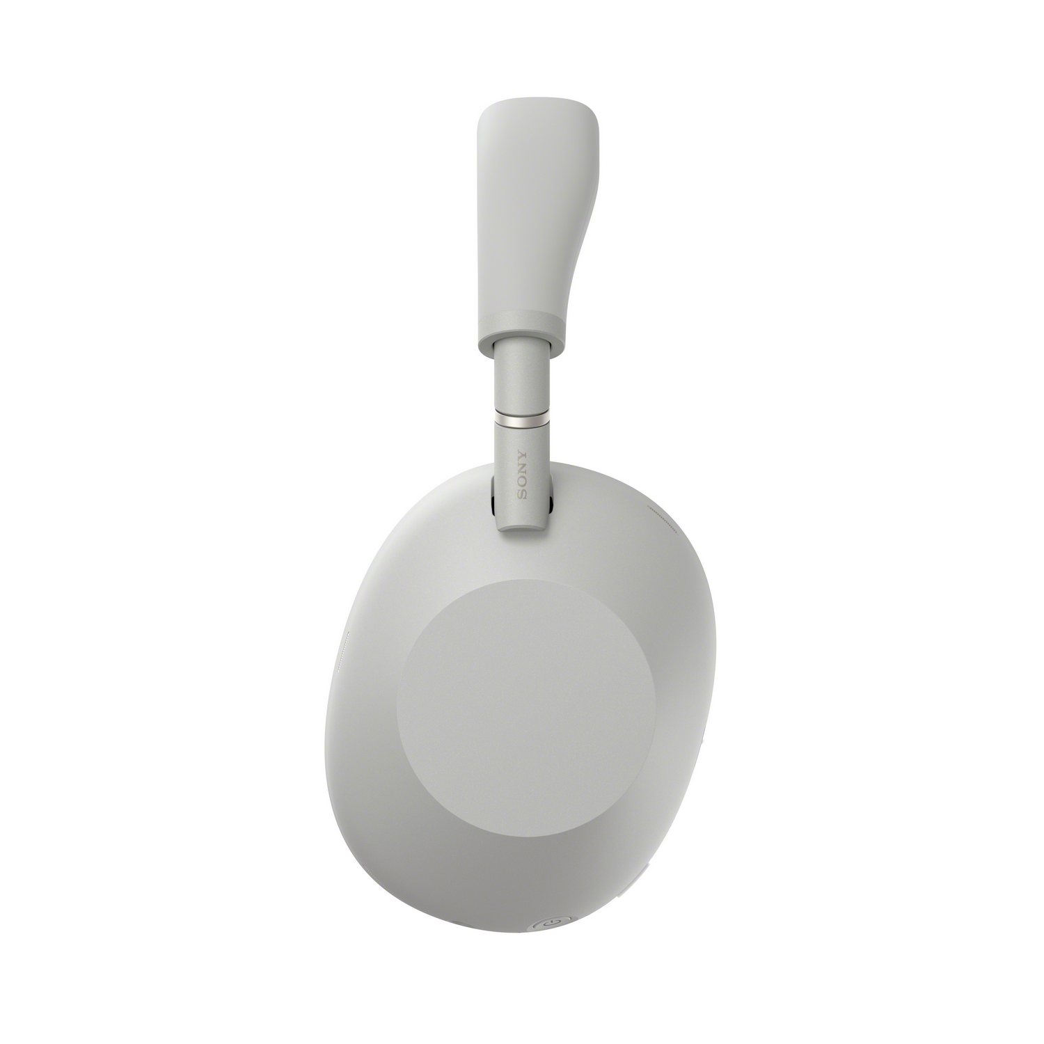 Vista superior de auriculares Sony grises. Diadema y copa visibles, logotipo Sony. Fondo blanco.