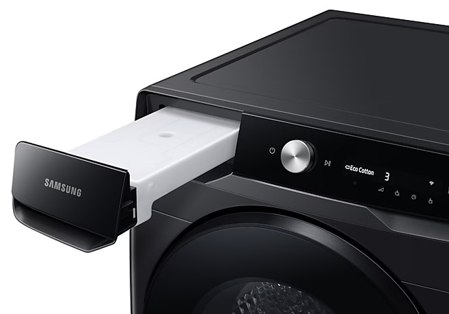 Czarna pralka z otwartą szufladą, widocznym białym pojemnikiem i panelem sterowania.