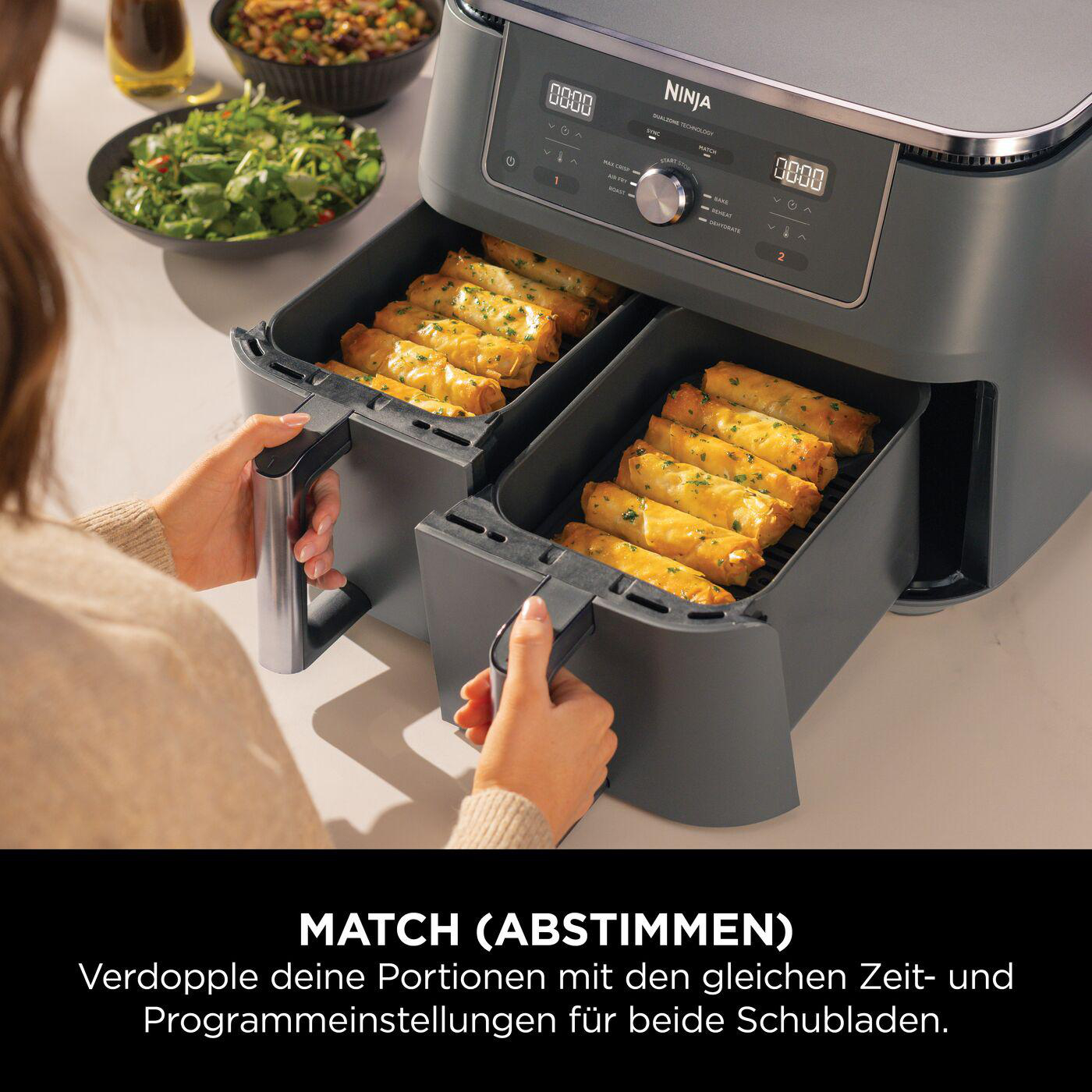 Nahaufnahme des Bedienfelds einer Heißluftfritteuse mit verschiedenen Kochfunktionen und einer Digitalanzeige.