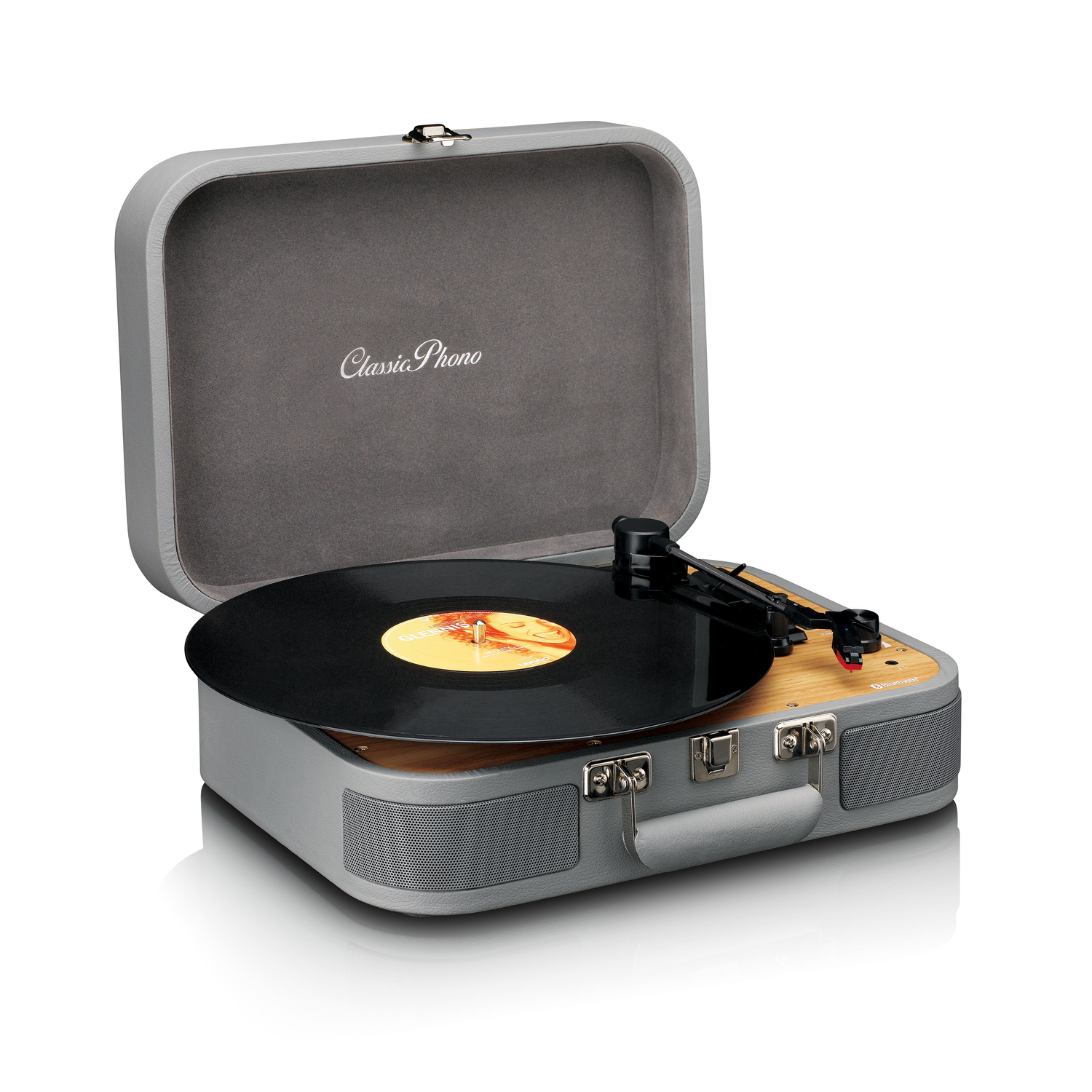 Open gray Classic Phono turntable. Black record spinning. Wooden panel and gray case.