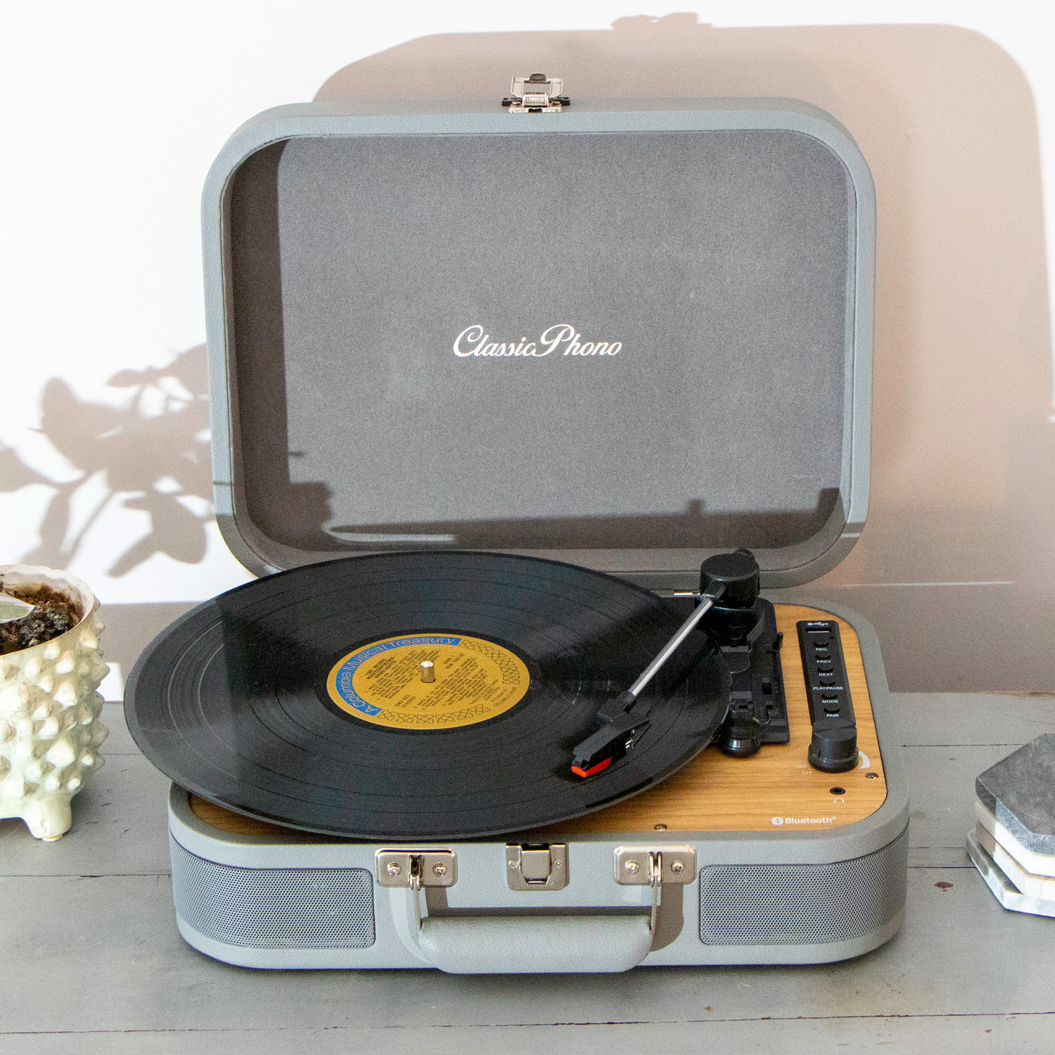 Open grey Lenco record player with a vinyl record playing on it. 'Classic Phono' printed on top.