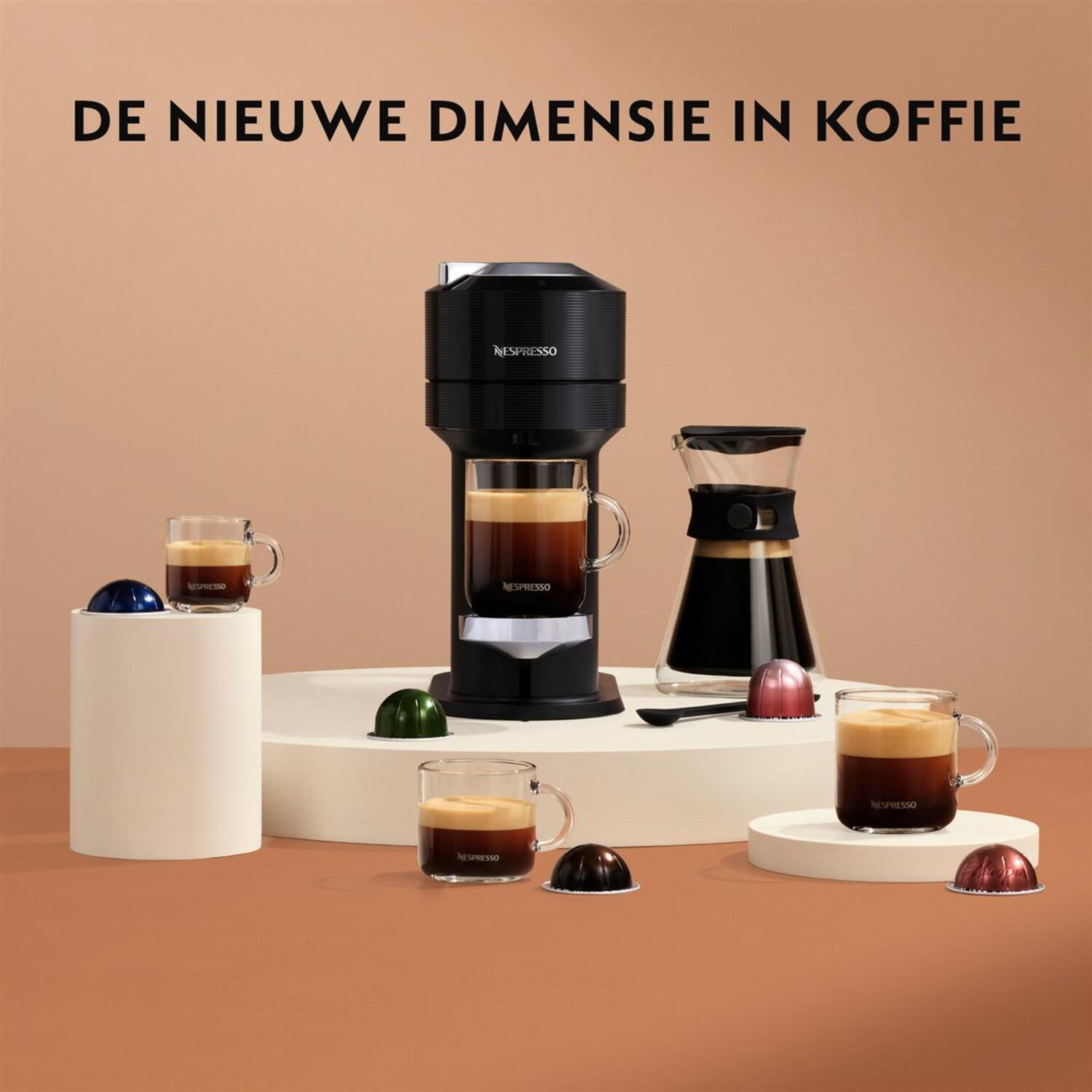 A black Nespresso machine, coffee cups, and capsules on a brown background.
