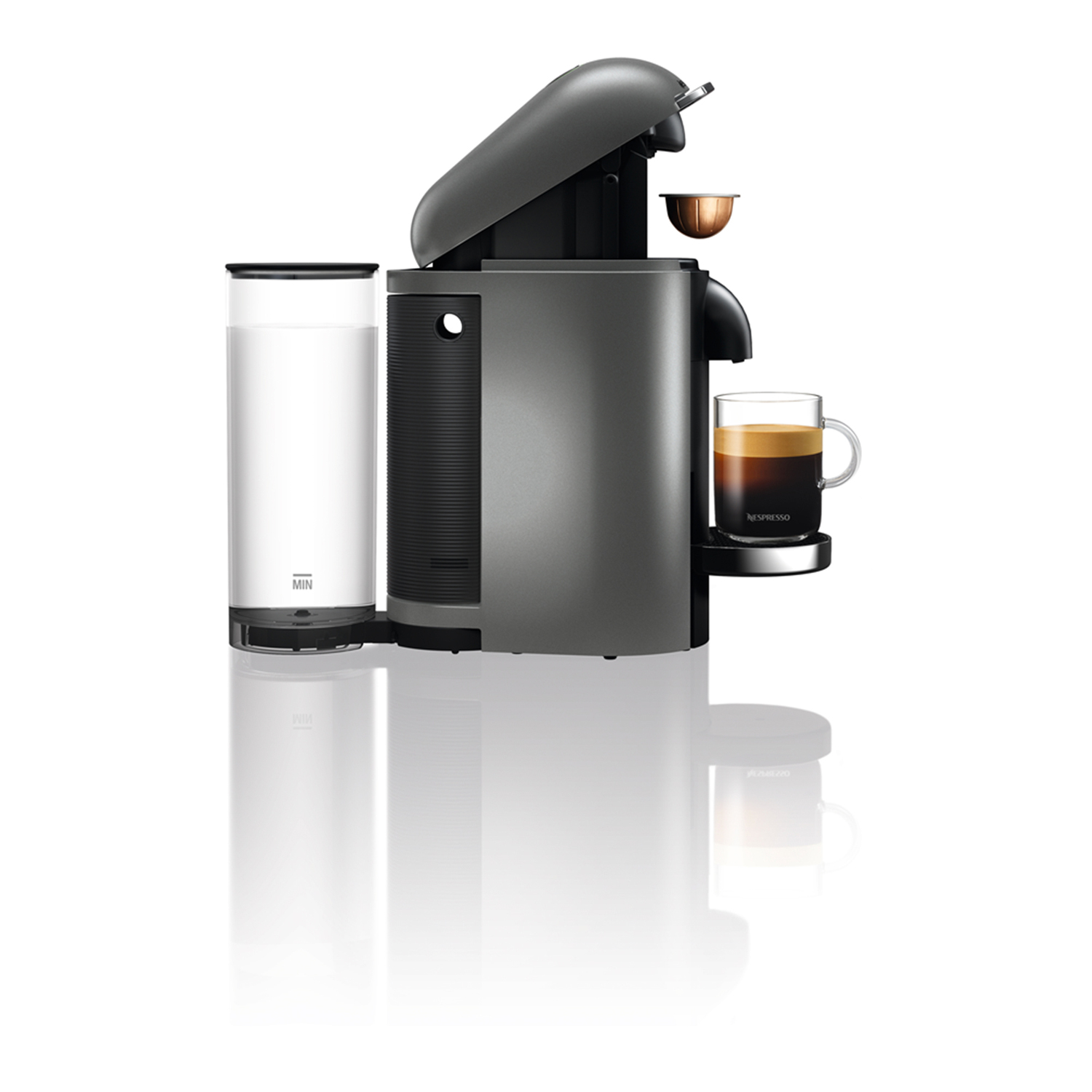 Gray Nespresso machine with cup of coffee. Water tank on the left. Isolated on white background.