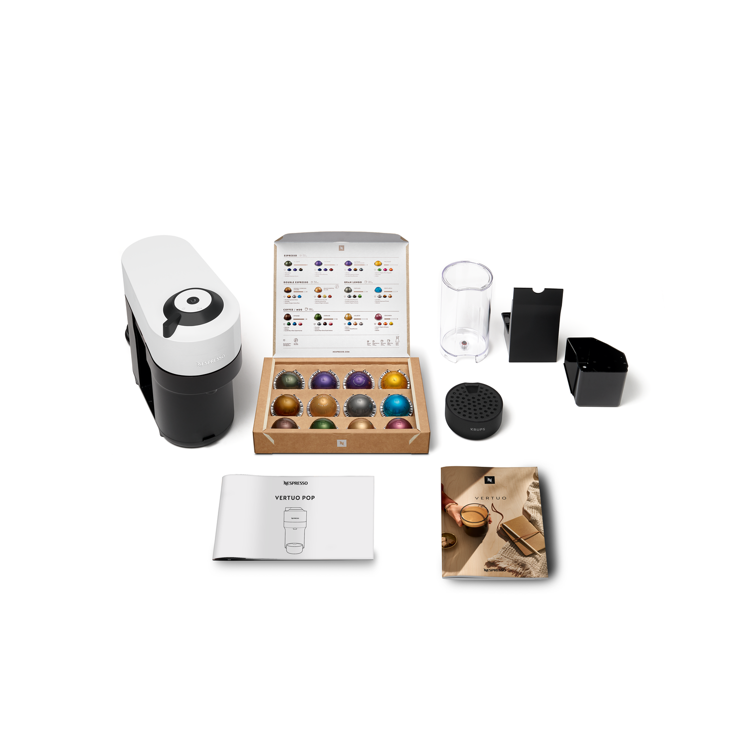 Coffee machine with box of capsules and accessories. White background. Variety of items.