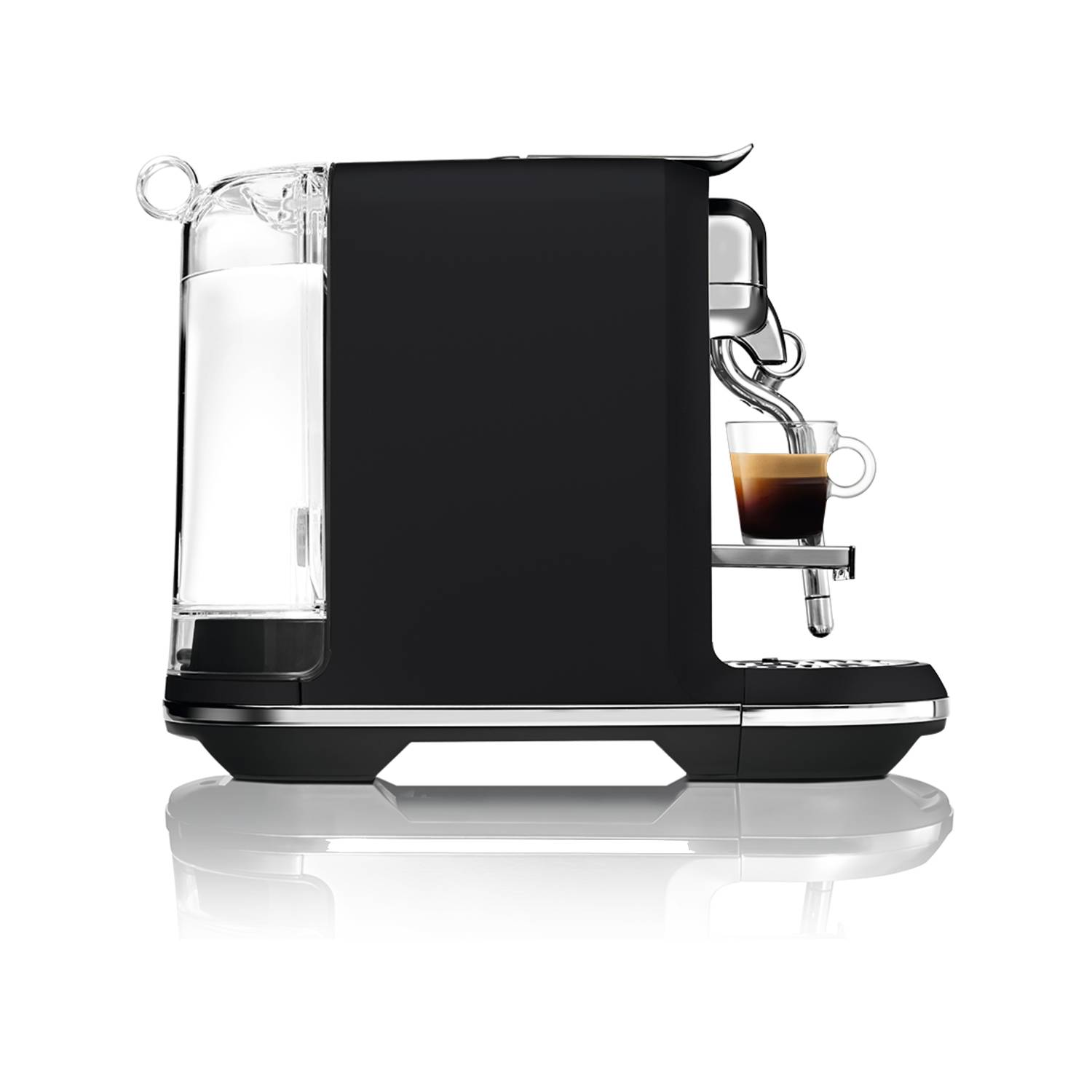 Black Nespresso coffee machine with a glass of coffee pouring into it.