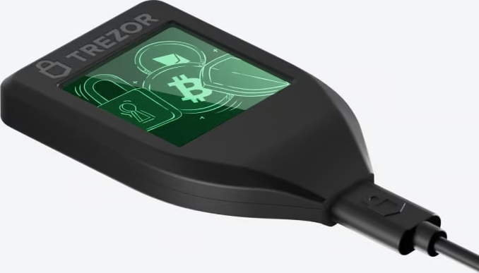 Un appareil noir avec un écran vert affichant des icônes et un cadenas, connecté à un câble.