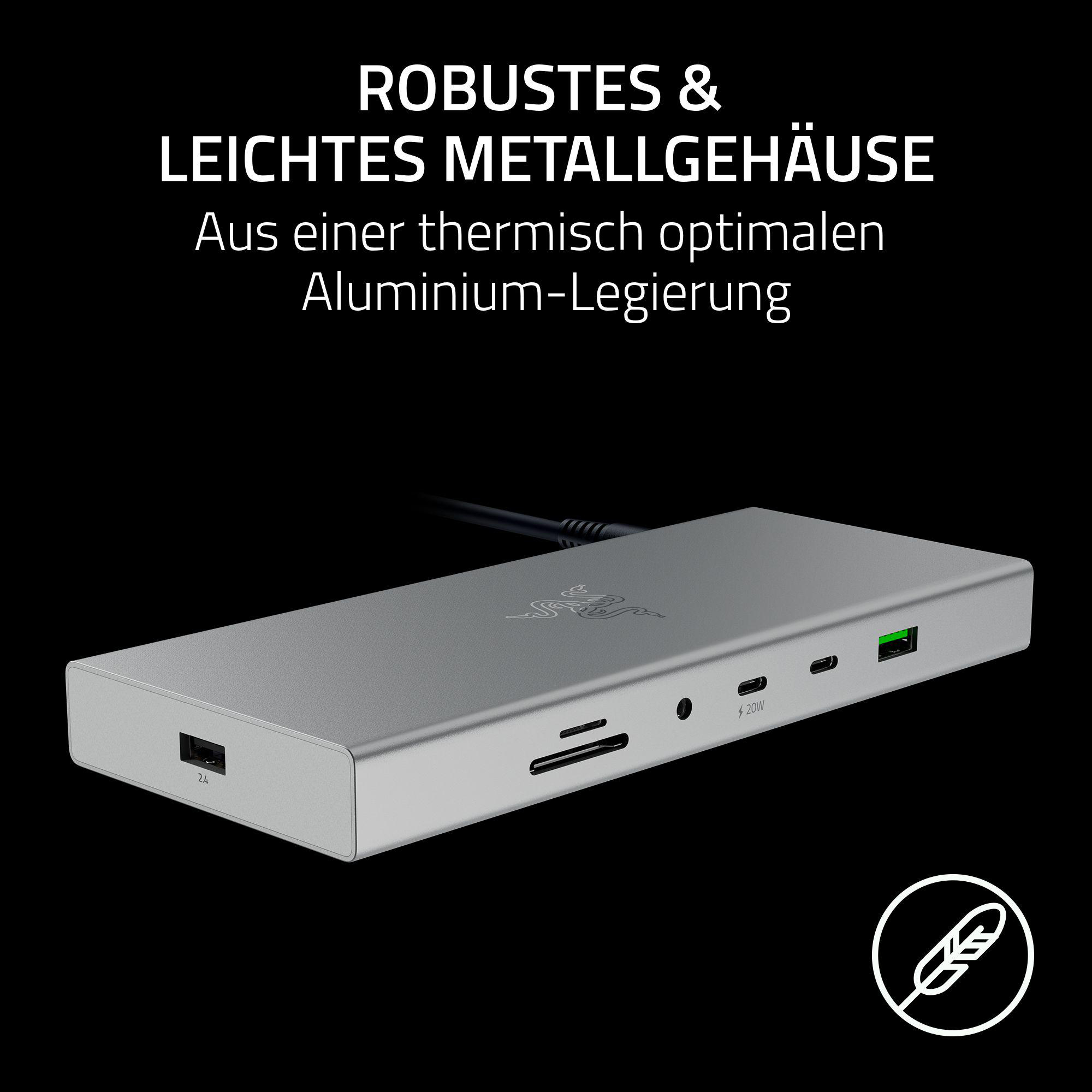 Silberne Razer-Dockingstation auf grauer Oberfläche. Die Dockingstation hat mehrere Anschlüsse und das Razer-Logo.