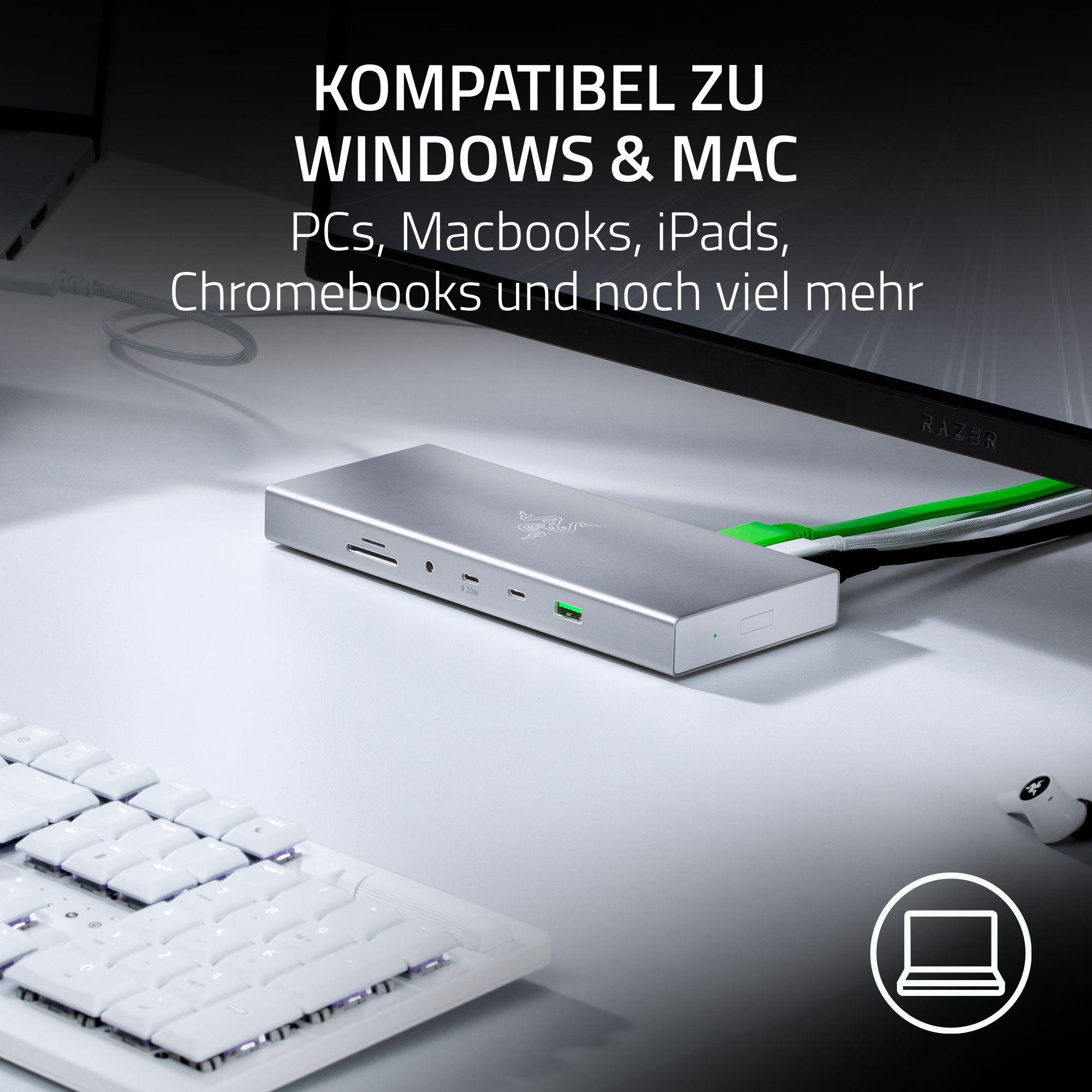 Razer-Dockingstation, die mit einem Laptop, einer Tastatur und einem Monitor auf einem Tisch verbunden ist.