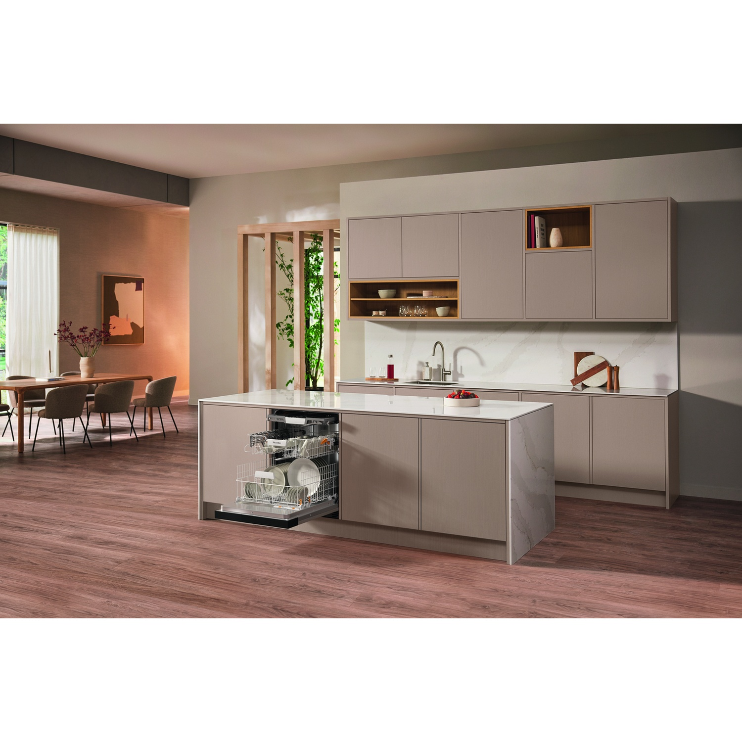 Cucina con lavastoviglie. La lavastoviglie è aperta, con piatti all'interno. Tavolo da pranzo sullo sfondo.
