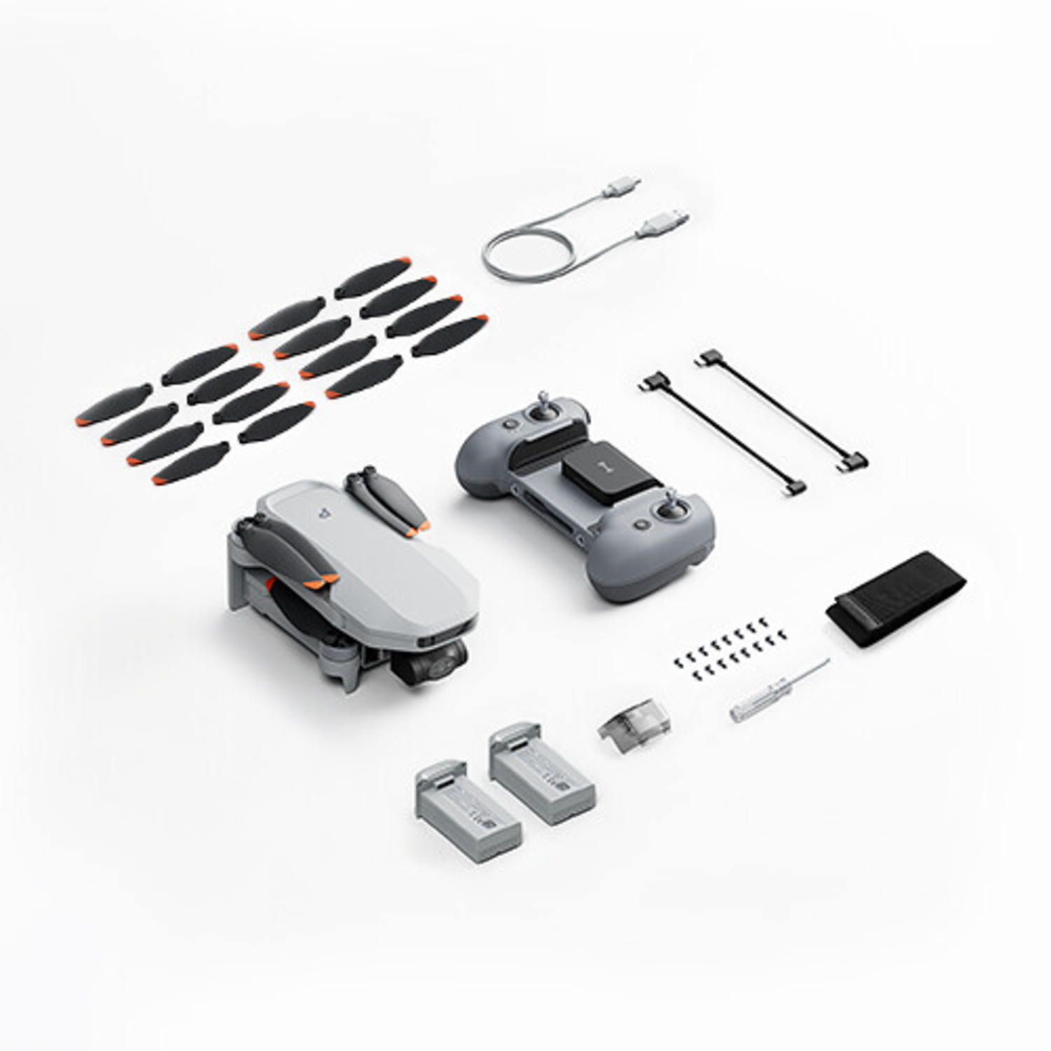 Drone with accessories: propellers, controller, batteries, cables, and a screwdriver.