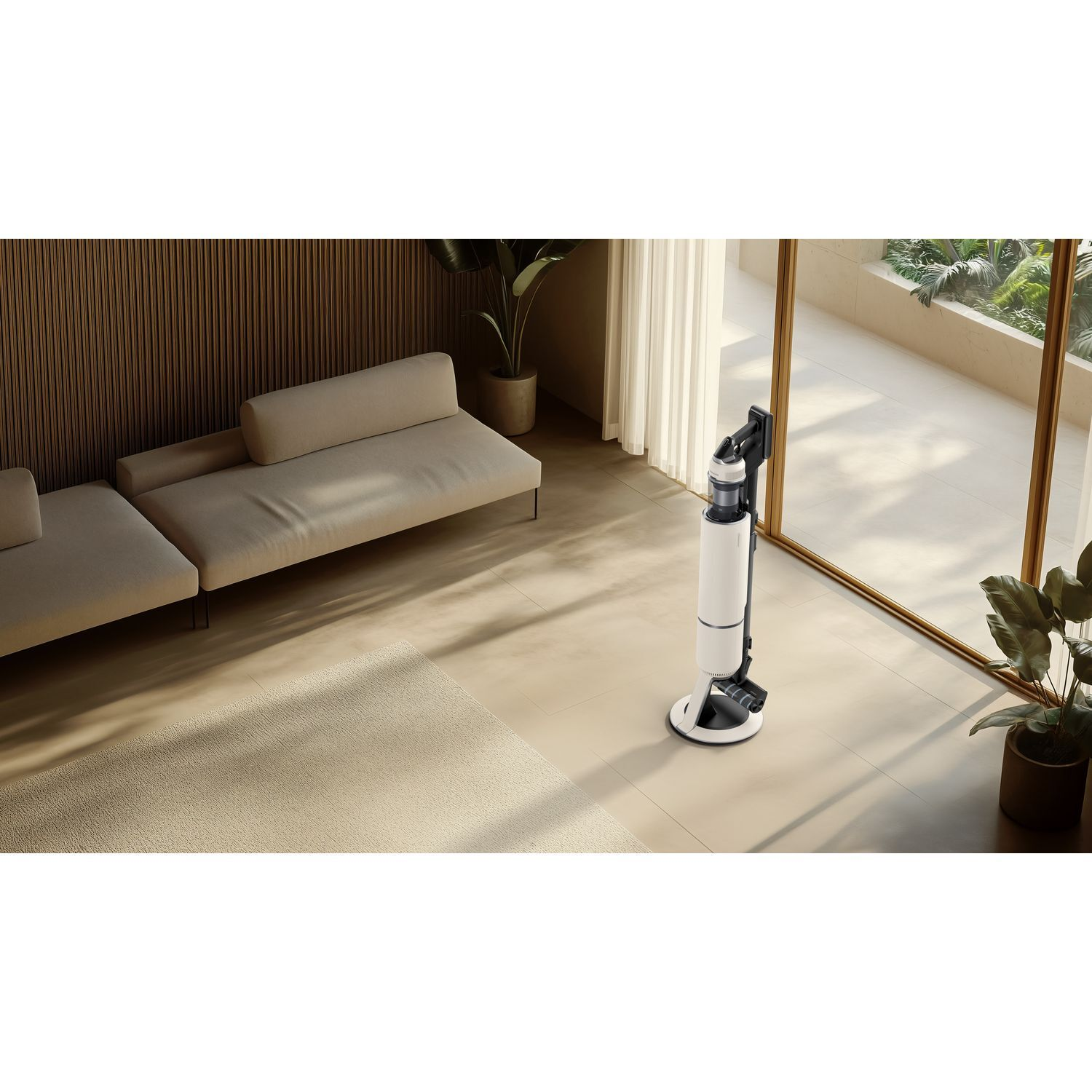 Room interior with a vacuum cleaner. White vacuum, beige couch, and plants visible.
