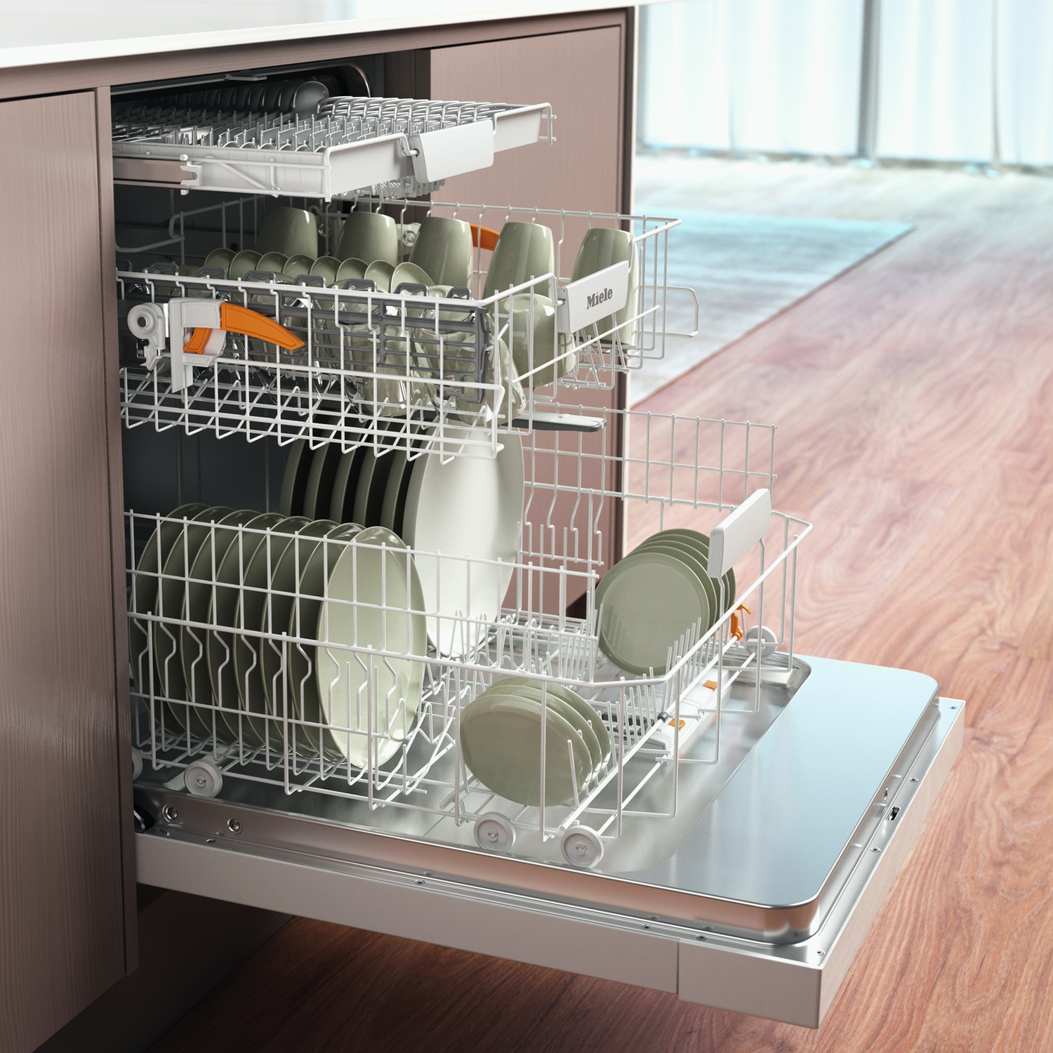 Lavastoviglie Miele aperta con cestelli carichi di piatti e bicchieri. Pavimento in legno.