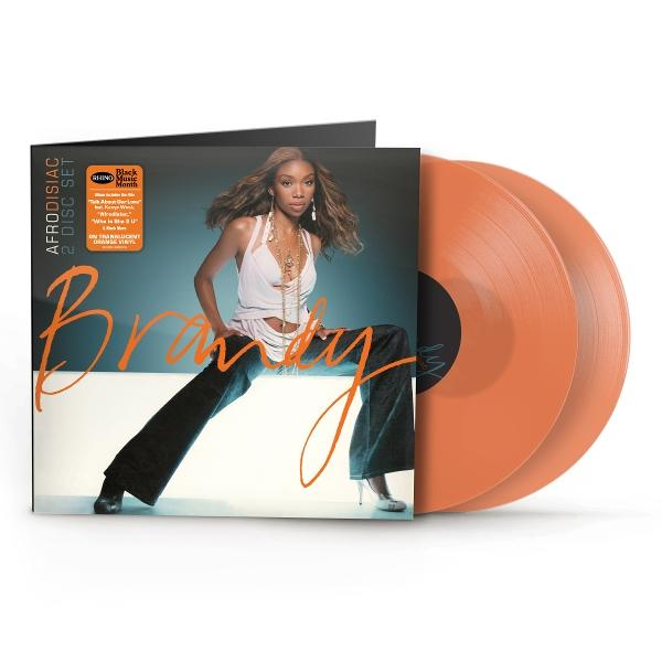 Brandy album borító, fehér felsőt és farmert viselve, narancssárga bakelit lemezekkel.