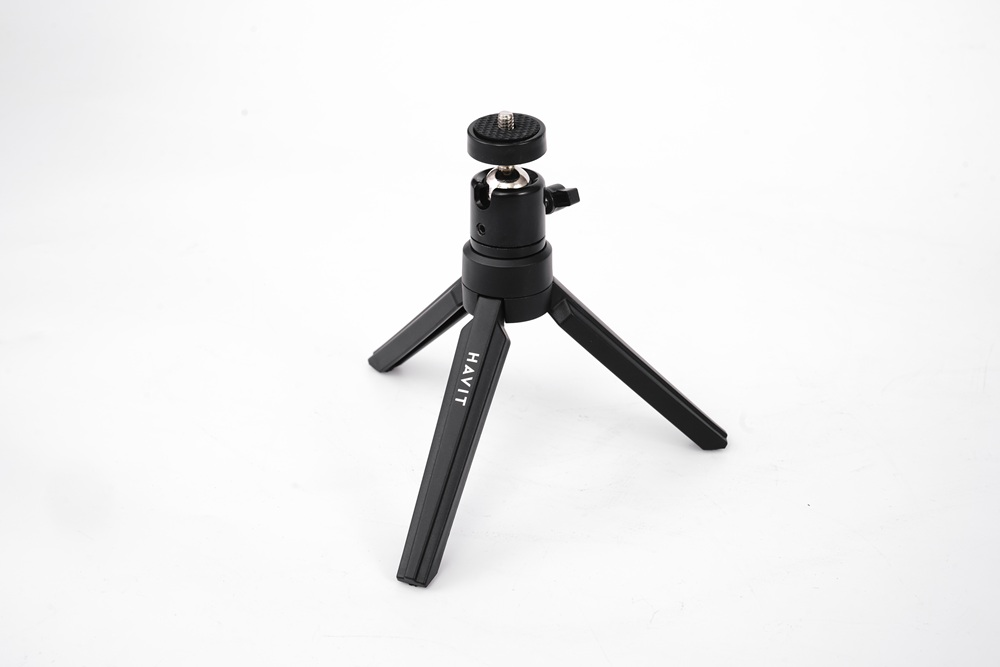 Siyah mini tripod. HAVIT metni. Ayarlanabilir kafalı üç bacak.
