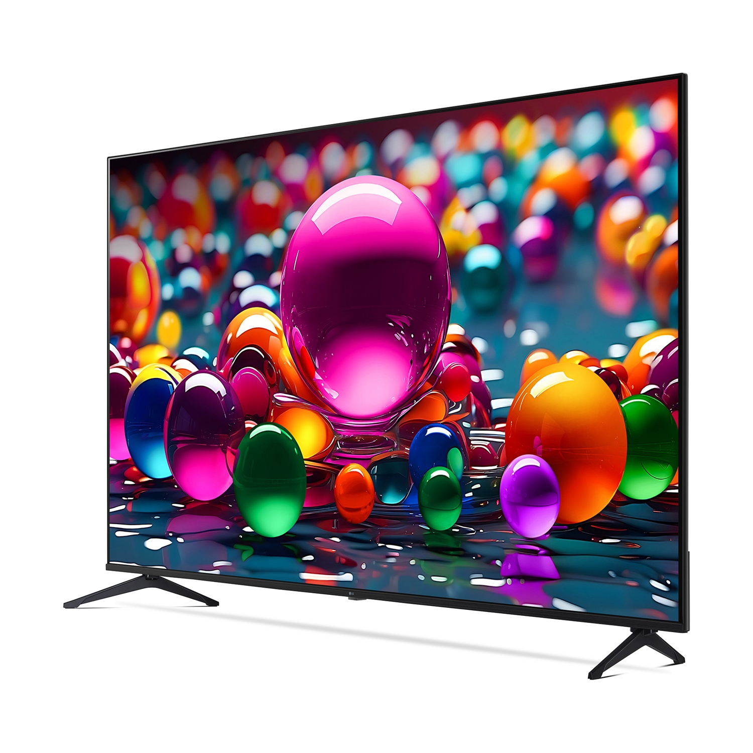 Un grande televisore mostra sfere colorate. Il televisore ha gambe e cornice nere. La scena è luminosa.