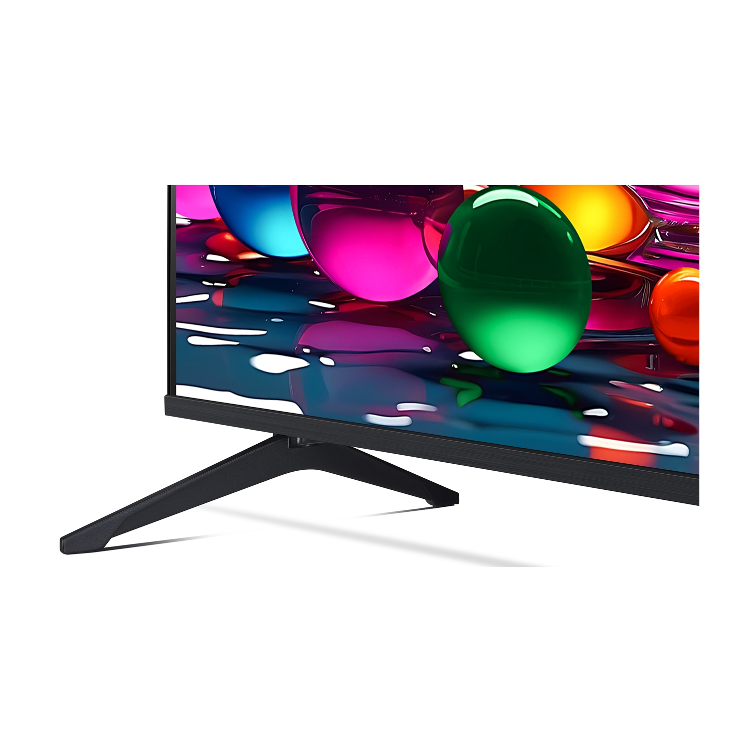 Primo piano delle gambe e del telaio neri di un televisore, su uno sfondo sfocato di sfere colorate.