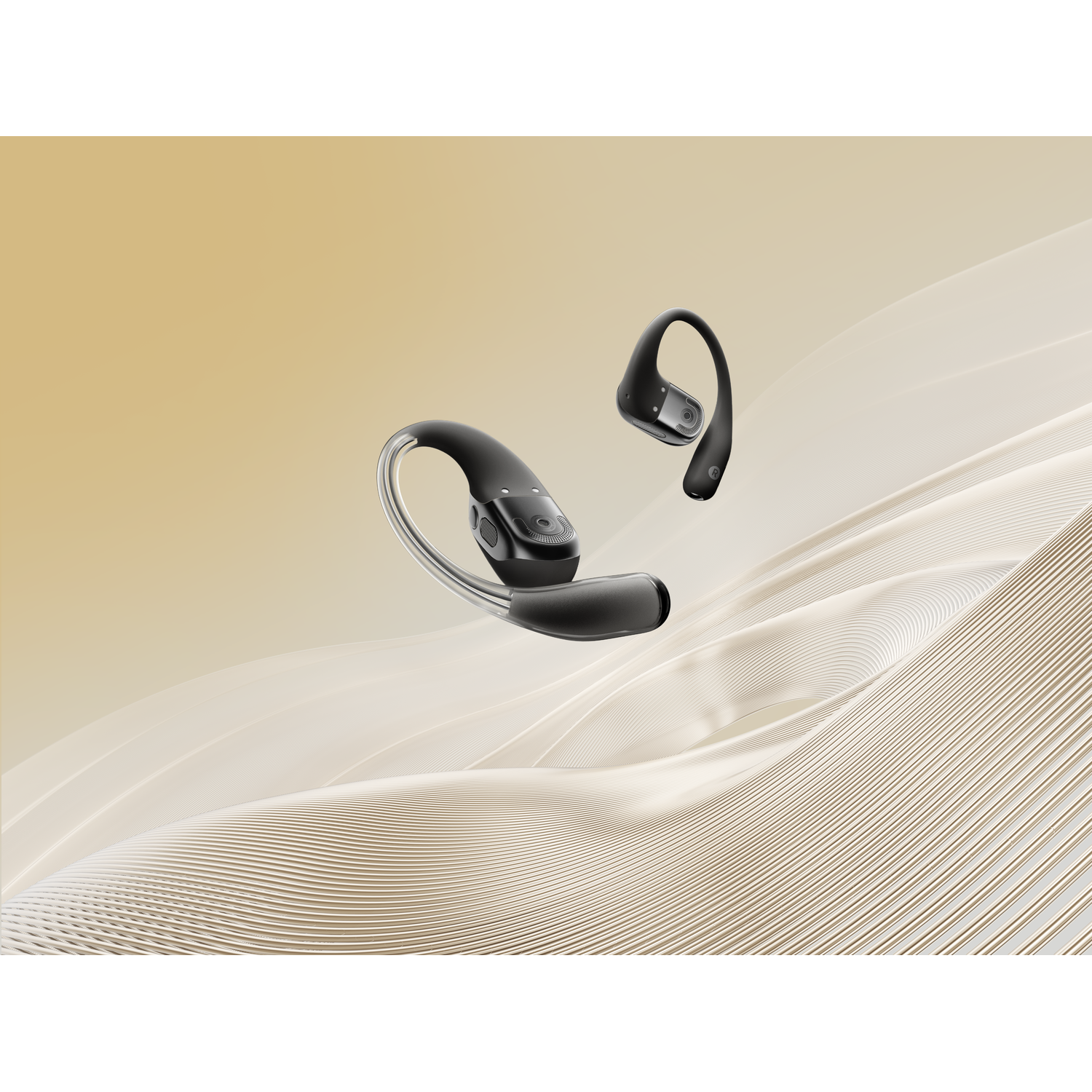 Two black Shokz headphones on a wavy surface.