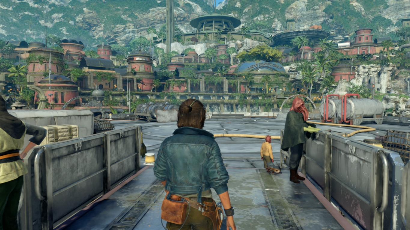 Osoba idąca po platformie. Budynki i góry w tle.