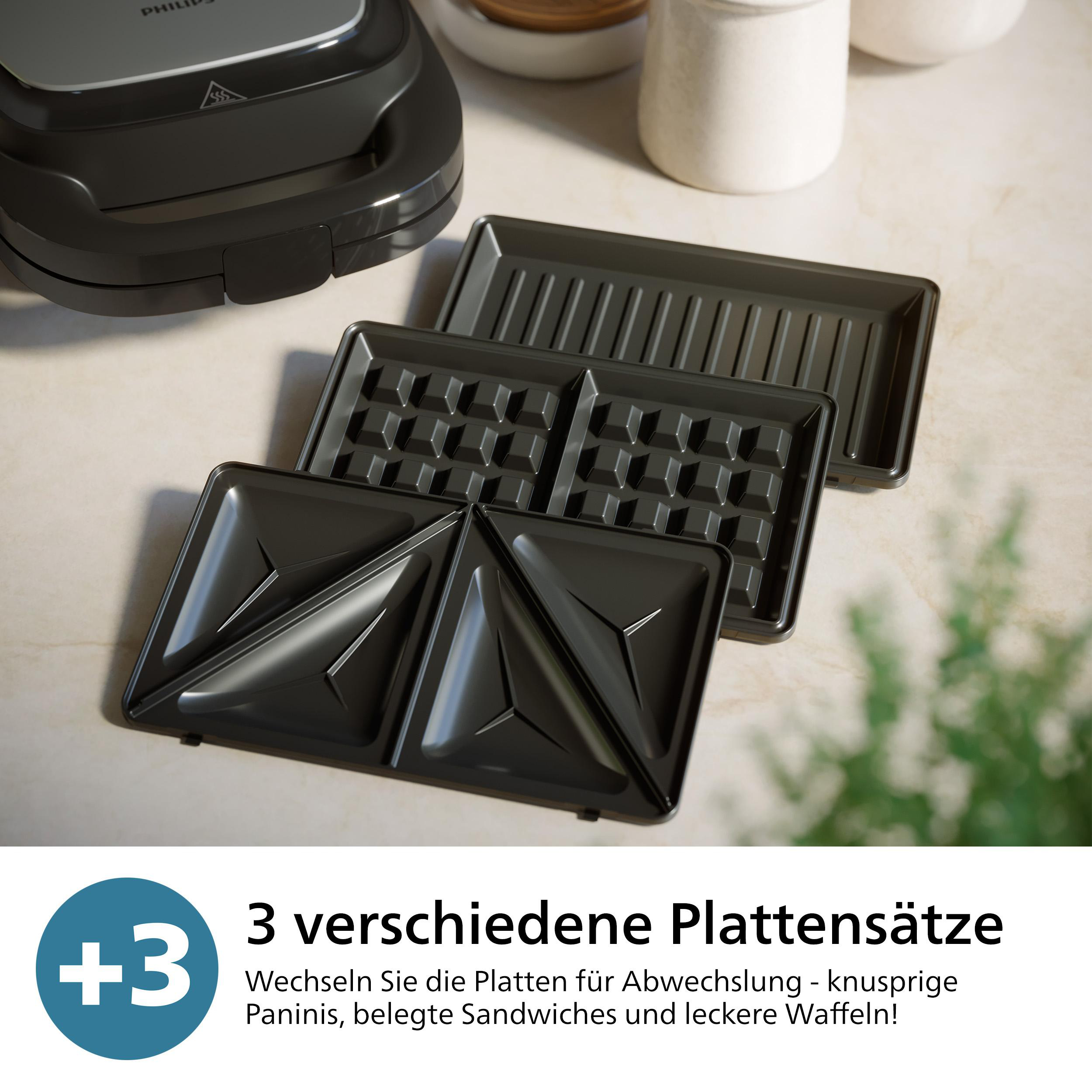 Mehrere austauschbare Platten für einen Sandwichmaker. Es gibt Waffel-, Grill- und Panini-Platten.