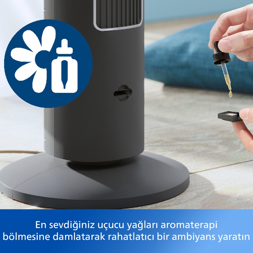 Koyu gri kule fanın yakın çekimi, el yağ damlacıklarını aroma odasına damlatıyor.