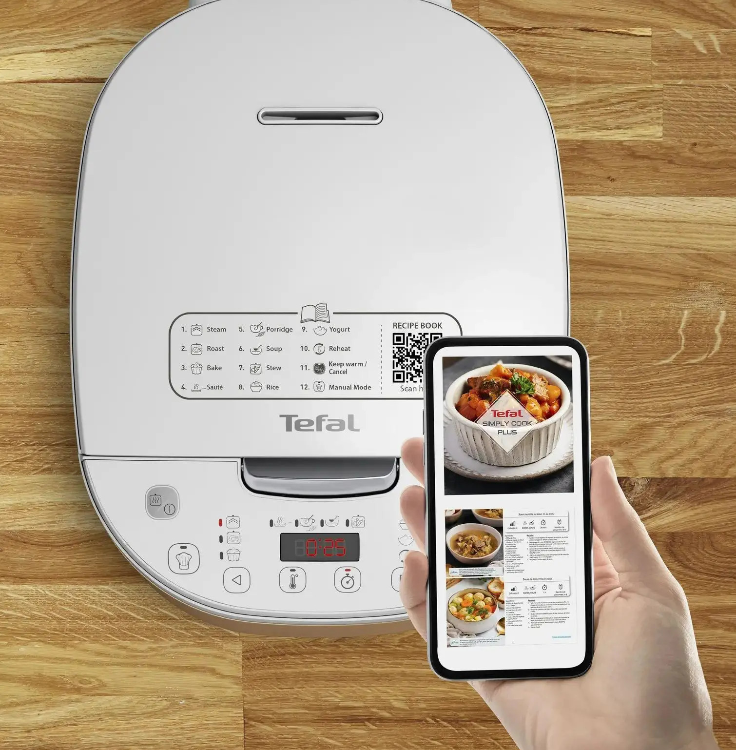 Biała maszynka do ryżu i smartfon z przepisem na drewnianej powierzchni.