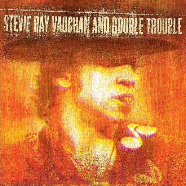 Albumcover: Stevie Ray Vaughan. Portrait in Orangetönen. Text: Stevie Ray Vaughan and Double Trouble. Mann mit Hut und Zigarette.