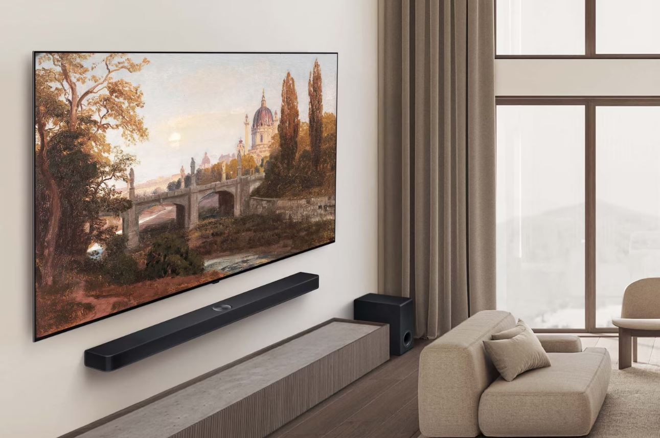 Duvarında LG OLED TV, altında soundbar ve modern bir kanepe ve dekor bulunan oturma odası.