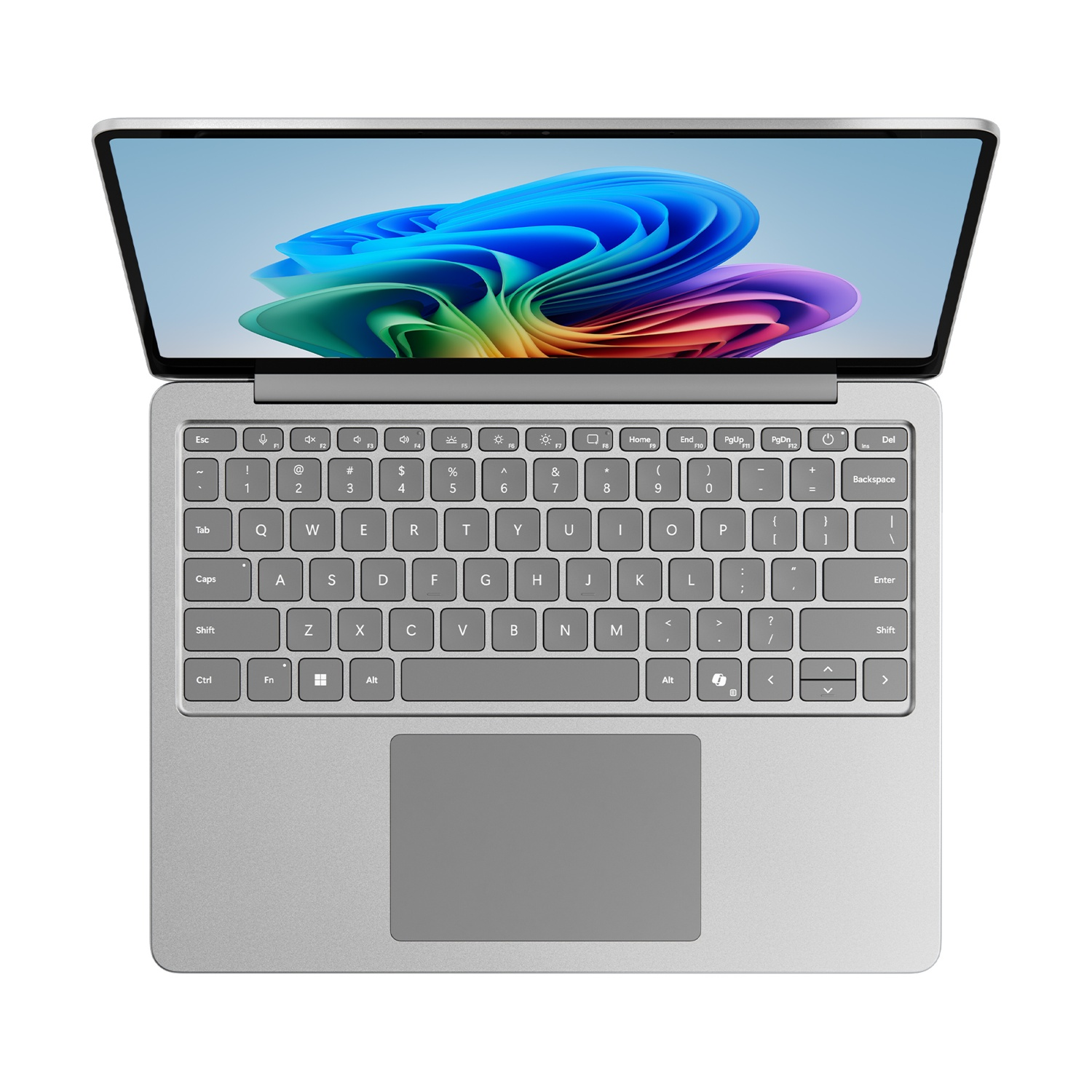 Laptop argentato, vista dall'alto, con un'immagine astratta colorata sullo schermo. Sfondo bianco.