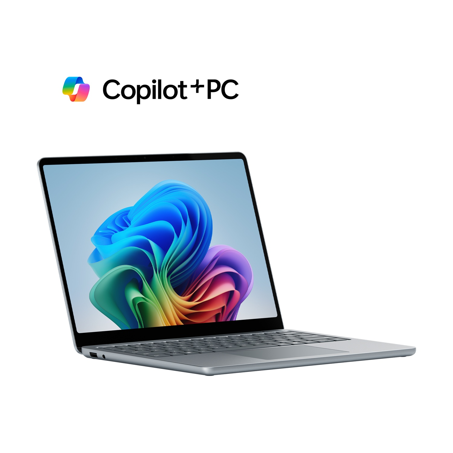 Laptop con immagine astratta colorata sullo schermo, accanto al testo 'Copilot + PC', su sfondo bianco.