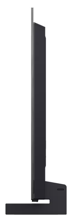 Tył czarnego telewizora, pokazujący porty, podstawę i teksturowaną, ciemnoszarą powierzchnię.